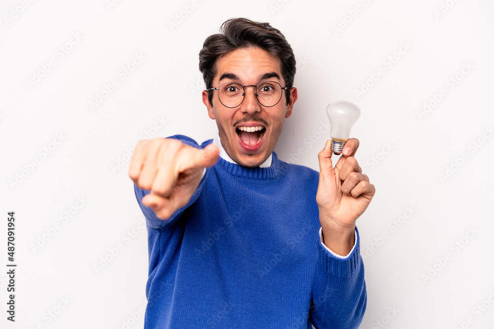 Young caucasian man holding a lightbulb isolated on white background Young caucasian man holding a lightbulb isolated on white background