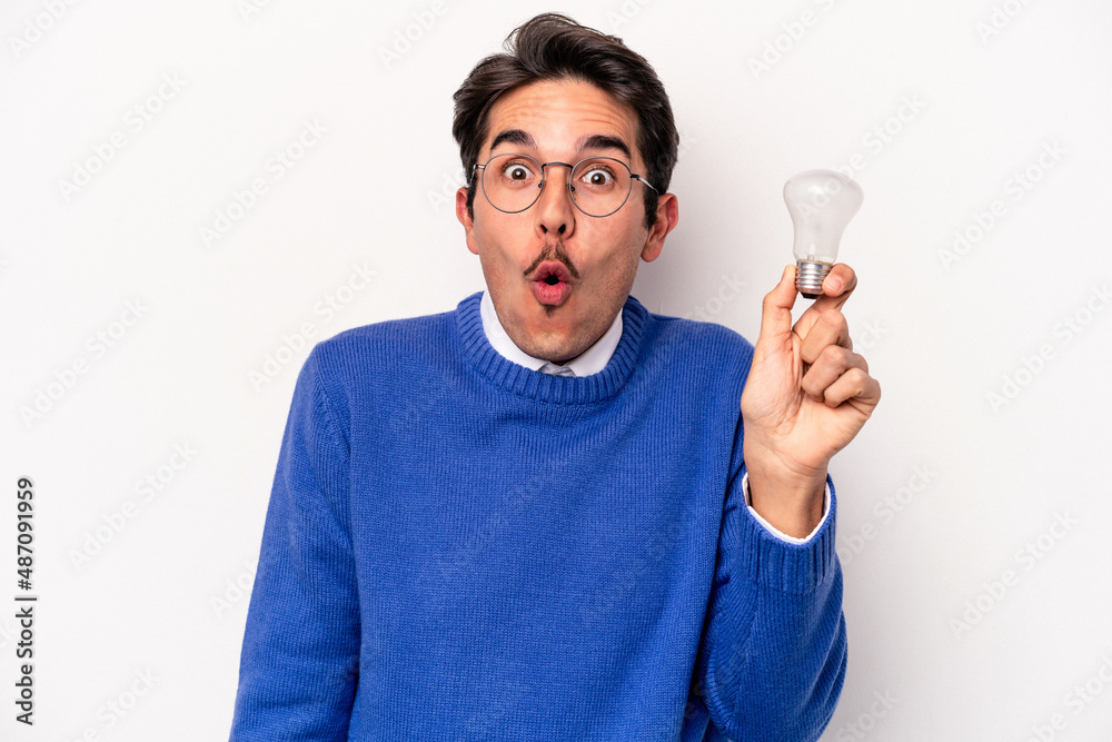 Young caucasian man holding a lightbulb isolated on white background Young caucasian man holding a lightbulb isolated on white background