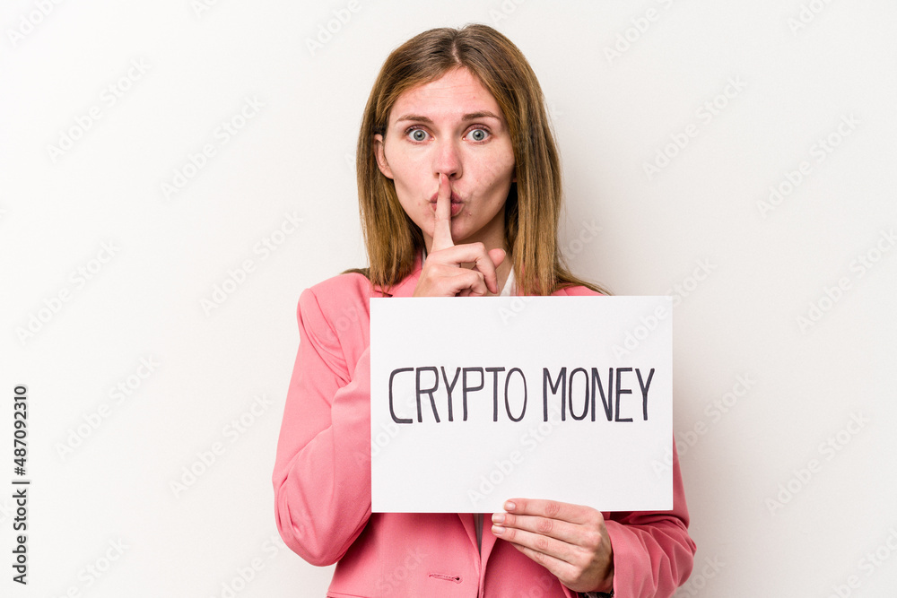 Young English business woman holding a crypto money placard isolated on white background keeping a secret or asking for silence. Young English business woman holding a crypto money placard isolated on white background keeping a secret or asking for silence.