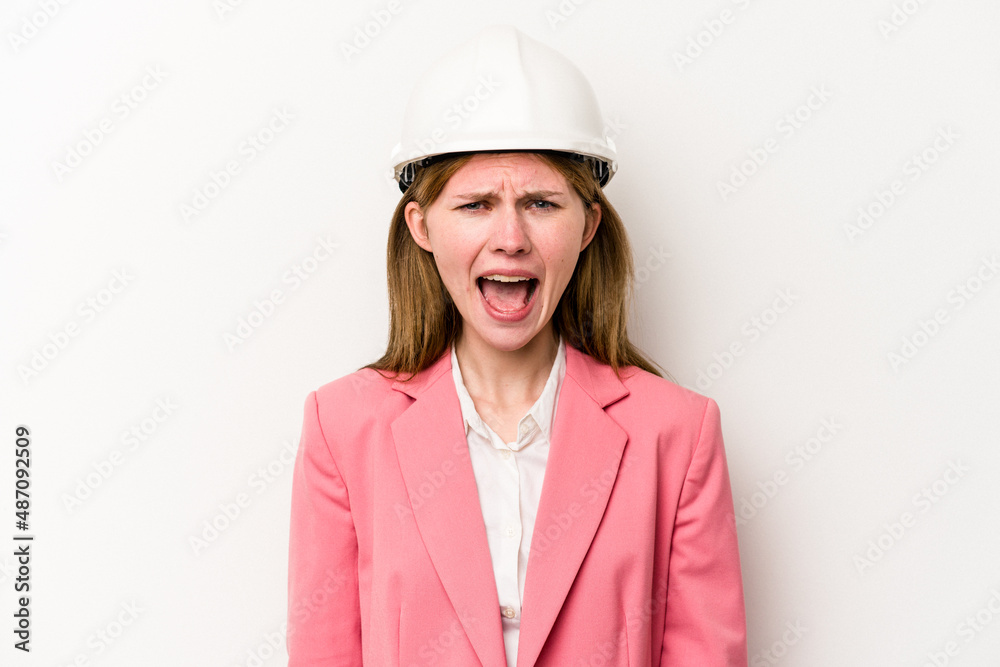 Young architect English woman with helmet isolated on white background screaming very angry and aggressive. Young architect English woman with helmet isolated on white background screaming very angry and aggressive.
