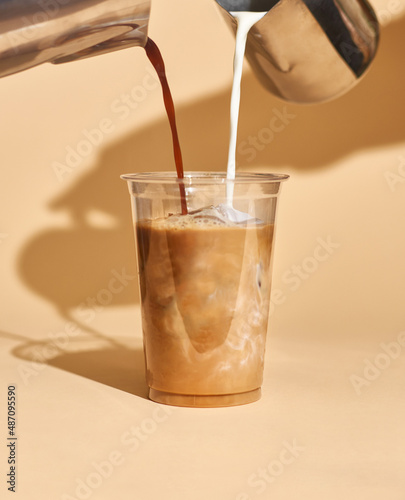 mockup of iced coffee milk in a plastic cup inside a cafe