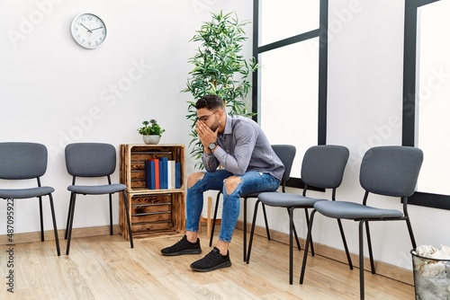 Young arab man desperate sitting on chair at waiting room © Krakenimages.com