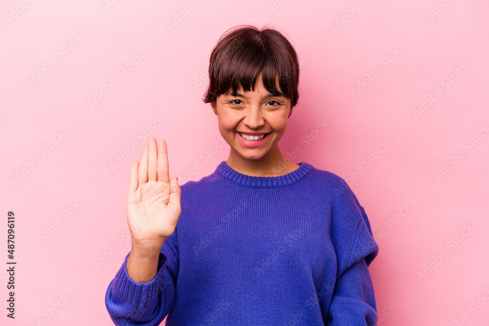 Young hispanic woman isolated on pink background smiling cheerful showing number five with fingers. Young hispanic woman isolated on pink background smiling cheerful showing number five with fingers.