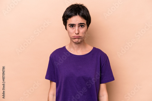 Wallpaper Mural Young caucasian woman isolated on beige background blows cheeks, has tired expression. Facial expression concept. Torontodigital.ca