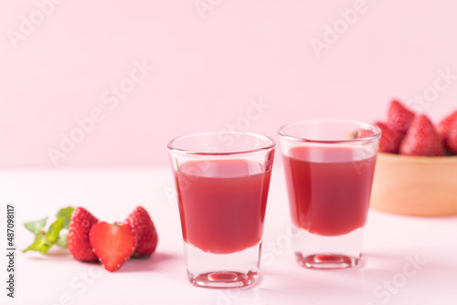 Strawberry juice in glass with fresh strawberry fruit on pink background, Healthy drink