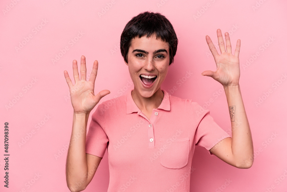 Young caucasian woman isolated on pink background receiving a pleasant surprise, excited and raising hands. Young caucasian woman isolated on pink background receiving a pleasant surprise, excited and raising hands.