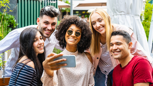 young group of people taking selfie, five person of generation Z enjoying moment together and sharing on social media network, multiracial diversity and digital native concept