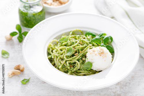 Pasta with basil pesto, cashew nuts and soft cream cheese