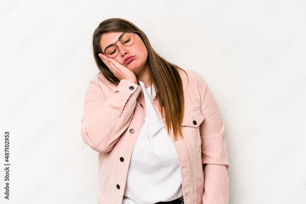 Young caucasian overweight woman isolated on white background who is bored, fatigued and need a relax day.