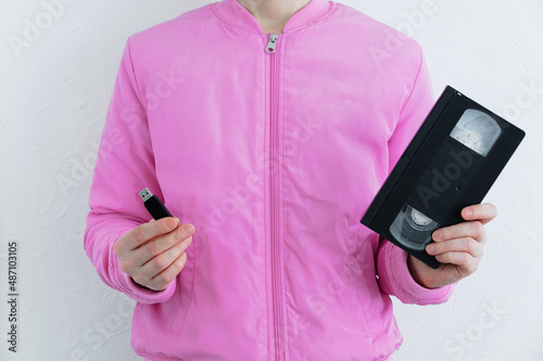 Vászonkép Video cassette and usb flash drive in the hands of caucasian woman