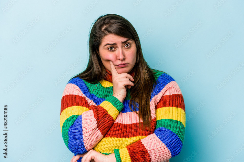 Young caucasian overweight woman isolated on blue background contemplating, planning a strategy, thinking about the way of a business. Young caucasian overweight woman isolated on blue background contemplating, planning a strategy, thinking about the way of a business.
