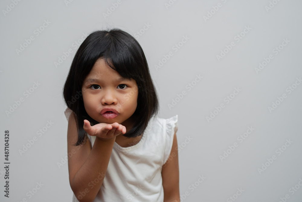 Portrait of happy and funny Asian child girl on white background, a child looking at camera. Preschool kid dreaming fill with energy feeling healthy and good concept Portrait of happy and funny Asian child girl on white background, a child looking at camera. Preschool kid dreaming fill with energy feeling healthy and good concept