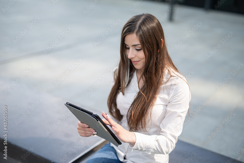 Businesswoman using a tablet outdoor