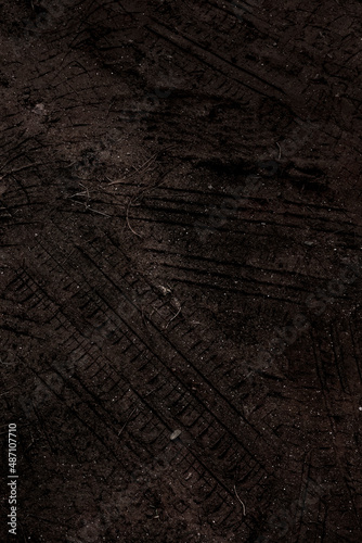Tyre track on dirt sand or mud, Picture in retro or grunge tone. Car drive on sand. off road track. Track on grass field. Track in farm.