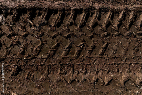 Tyre track on dirt sand or mud, Picture in retro or grunge tone. Car drive on sand. off road track. Track on grass field. Track in farm.