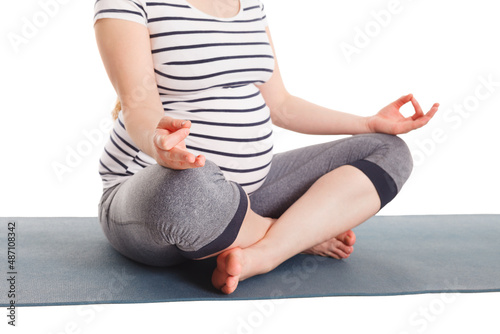 Pregnancy yoga exercise - pregnant woman doing asana padmasana with chin mudra lotus pose isolated on white background
