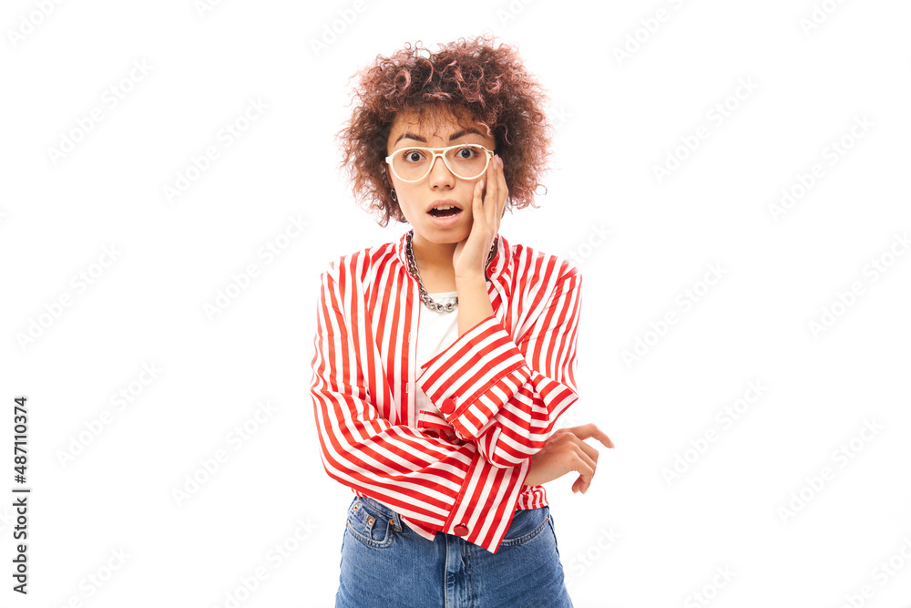 Shocked kazakh girl face with afro curls and open mouth holding head with hands looks surprised on white studio background with copy space Shocked kazakh girl face with afro curls and open mouth holding head with hands looks surprised on white studio background with copy space