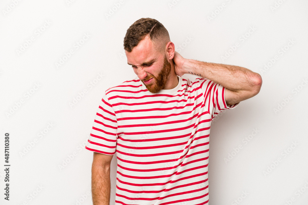 Obraz premium Young caucasian man isolated on white background suffering neck pain due to sedentary lifestyle.