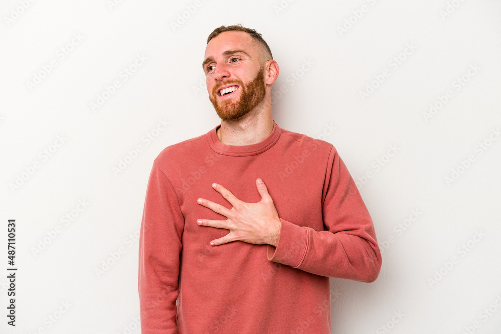Young caucasian man isolated on white background laughs out loudly keeping hand on chest. Young caucasian man isolated on white background laughs out loudly keeping hand on chest.