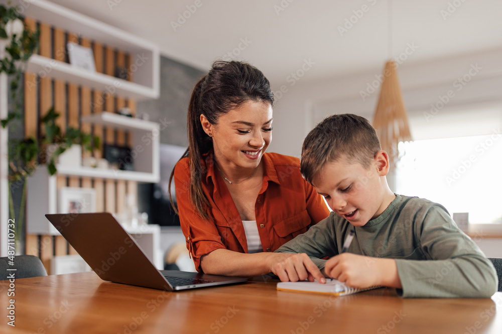Nice caucasian woman, teaching her smart boy how to write. Nice caucasian woman, teaching her smart boy how to write.