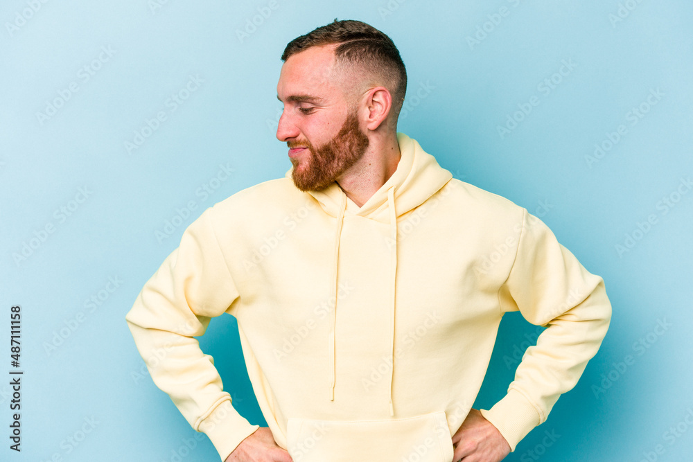 Young caucasian man isolated on blue background dreaming of achieving goals and purposes Young caucasian man isolated on blue background dreaming of achieving goals and purposes