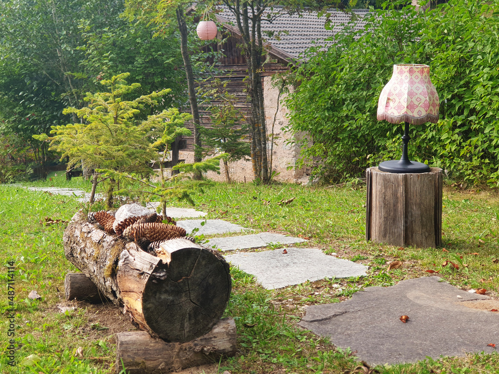 Unusual garden interior with a floor lamp in the yard. Unusual garden interior with a floor lamp in the yard.