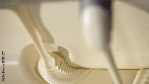Close-up macro shot melted liquid white chocolate sauce .