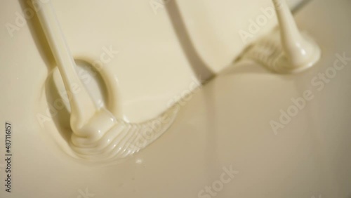 Close-up macro shot melted liquid white chocolate sauce .