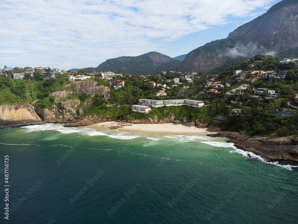 Aerial view of Praia da Joatinga, a paradise in Rio de Janeiro, Brazil. Sunny day with some clouds in the morning. Sea with good waves for surfers. Drone photo