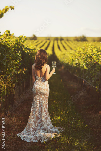 Obraz na plátně Image of girl holding wineglasse with wine