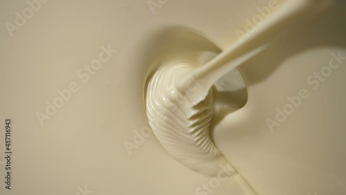 Close-up macro shot melted liquid white chocolate sauce .