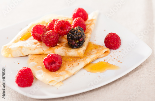 pancakes with raspberries, blackberries and honey