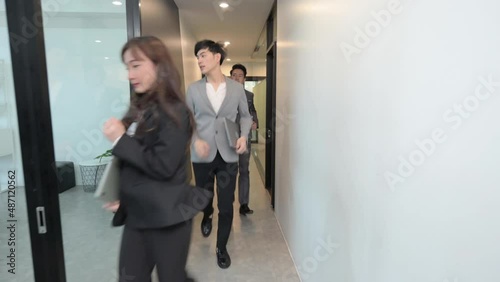 Group of young Asian business people running to get out of the office, Fire escape concept photo