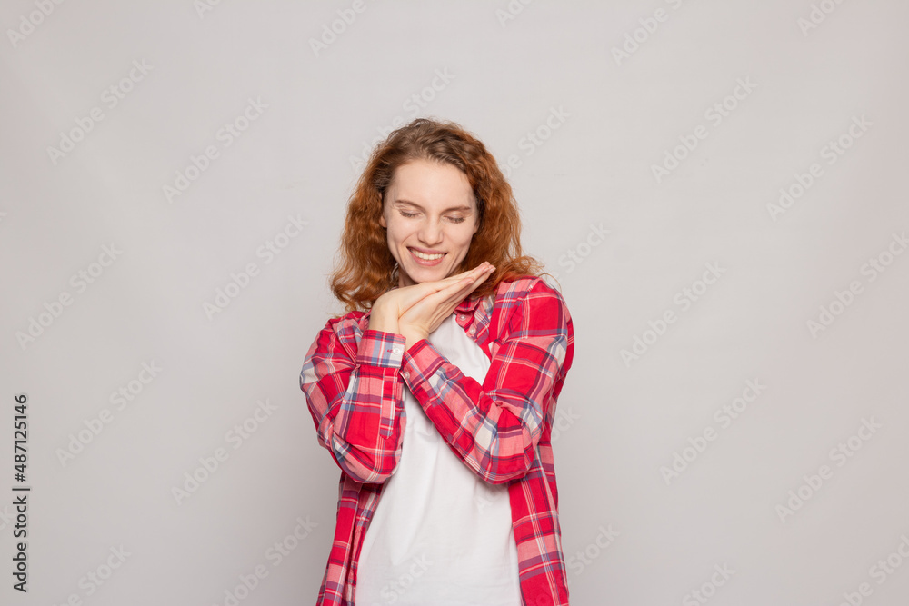 red-haired young girl in a plaid shirt on a white background with a place for text red-haired young girl in a plaid shirt on a white background with a place for text