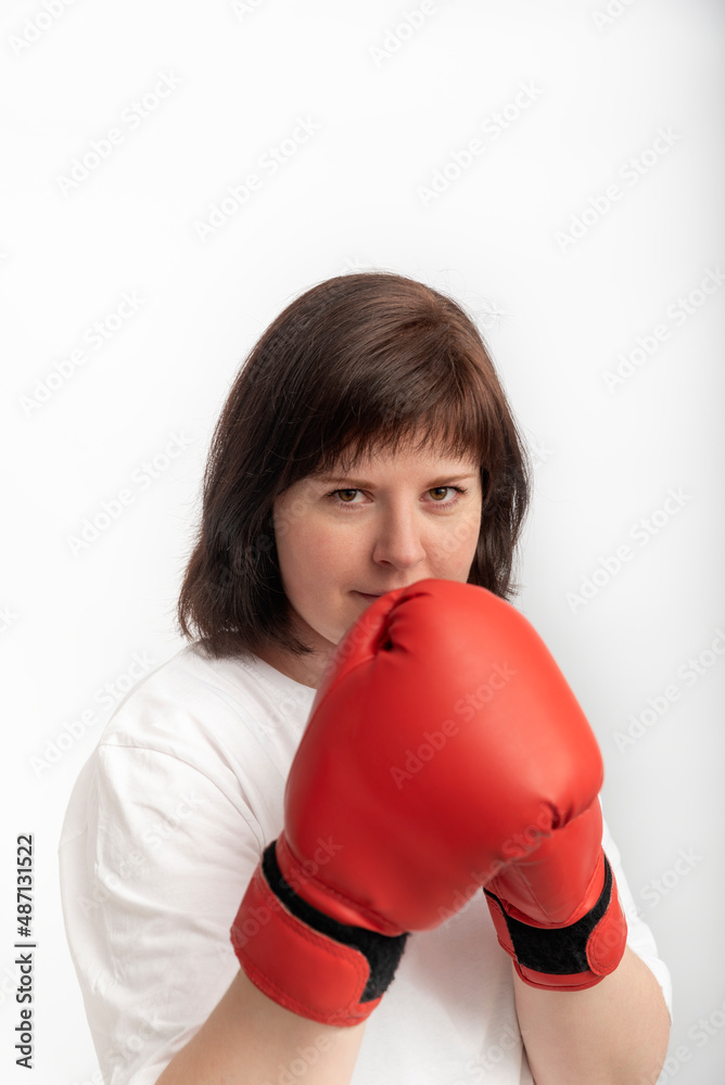 Portrait of young caucasian woman in boxing gloves on white background. Vertical frame Portrait of young caucasian woman in boxing gloves on white background. Vertical frame
