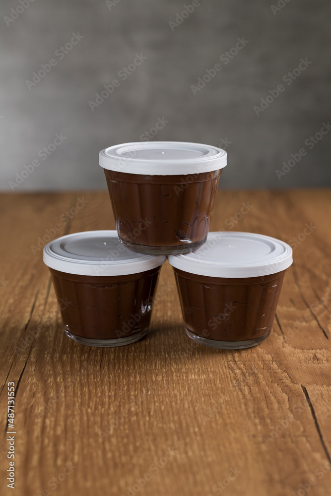Brazillian chocolate sweet called Brigadeiro in pot on wooden desk background. Vegan version Brazillian chocolate sweet called Brigadeiro in pot on wooden desk background. Vegan version