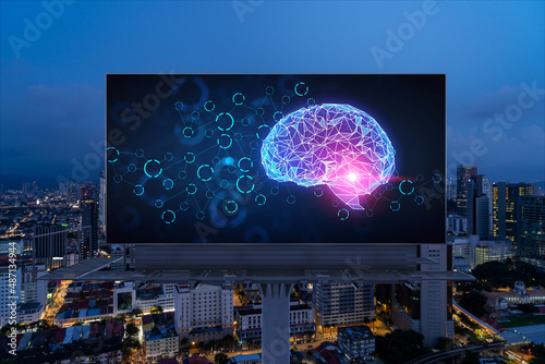 Photography Brain hologram on billboard with Kuala Lumpur cityscape background at night time