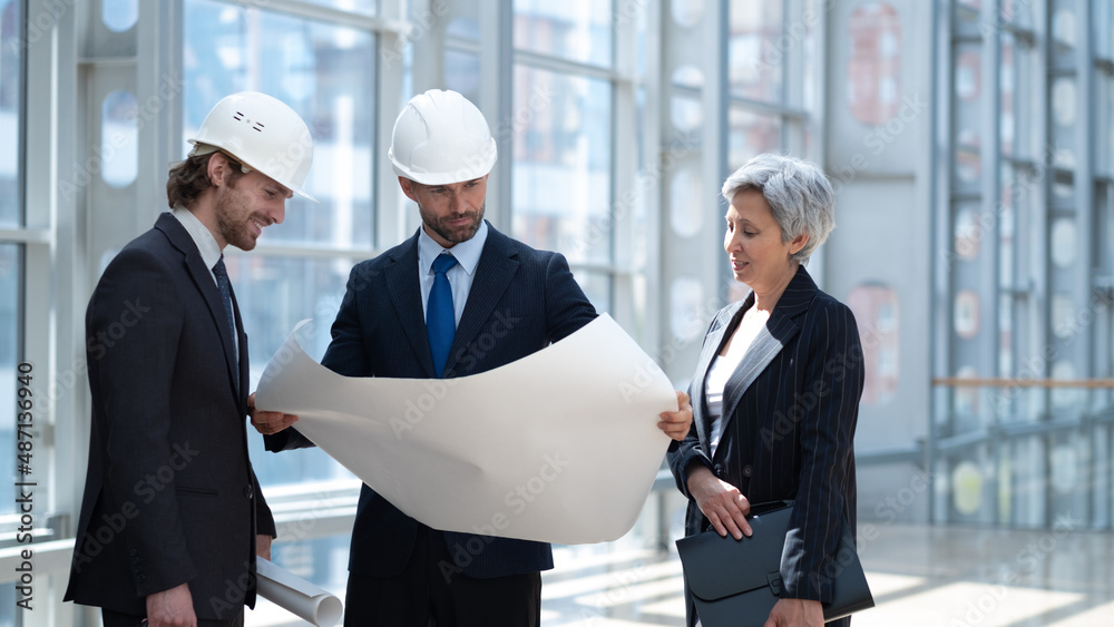 Architect discuss blueprint Architect discuss blueprint