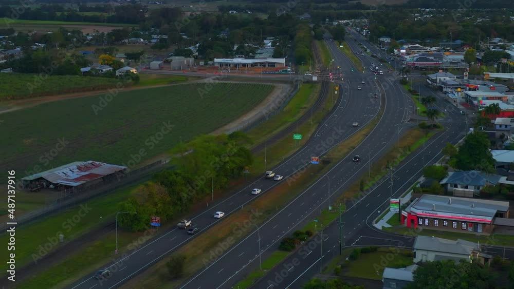 Traveling Cars On A Highway In Countryside Town Of Cairns In Queensland, Australia. Aerial Drone Traveling Cars On A Highway In Countryside Town Of Cairns In Queensland, Australia. Aerial Drone