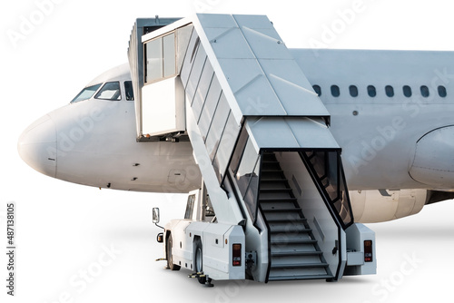 Passenger airliner with a boarding ramp isolated on white background