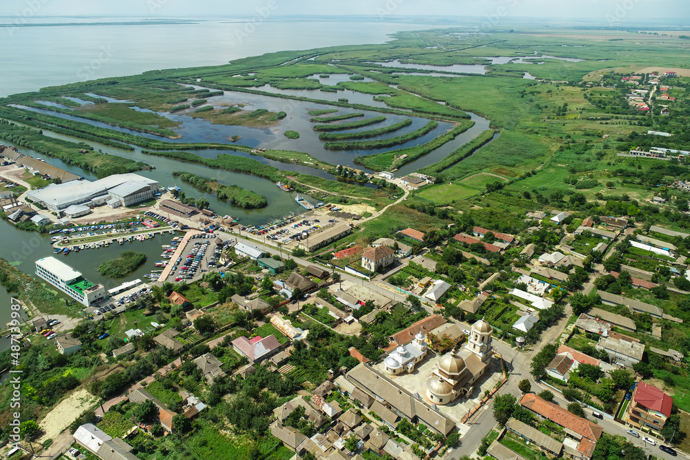 Aerial view over Jurilovca village from Dobrogea, Romania, with its church and harbour to Razim Lake and Danube Delta
