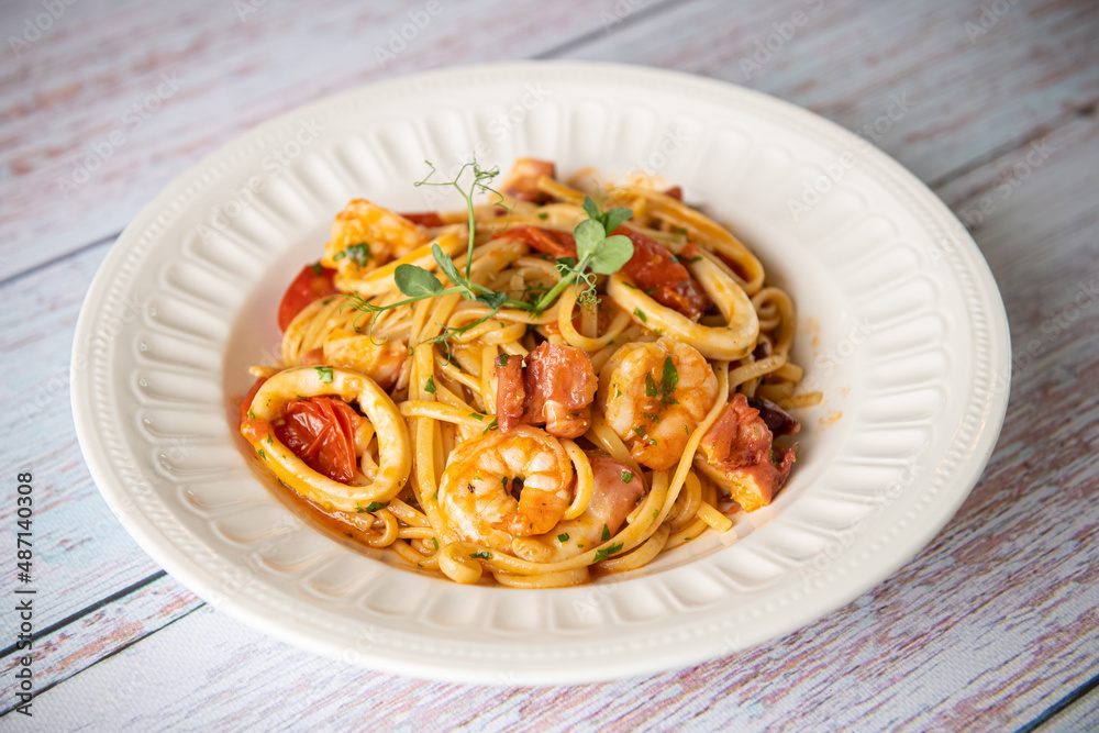 Food photography. Close up view of a dish with shrimp spaghetti pasta. Delicious seafood.
