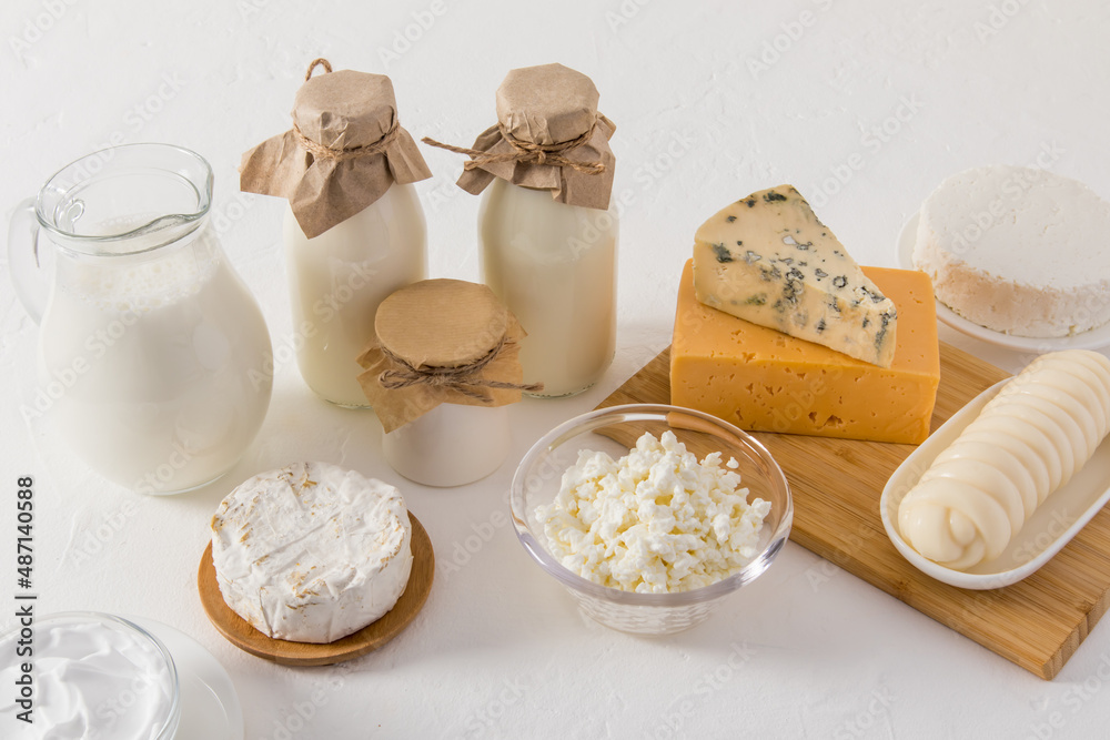 fresh dairy homemade natural products for daily consumption. milk, cottage cheese, cheese, yogurt in various dishes on a white background. fresh dairy homemade natural products for daily consumption. milk, cottage cheese, cheese, yogurt in various dishes on a white background.