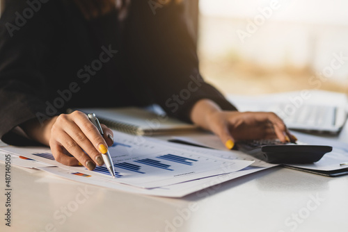 Close-up businesswoman working in accounting, analyzing and planning finances.