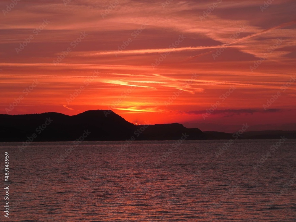 beautiful bright colourful sunset over the sea and cliffs