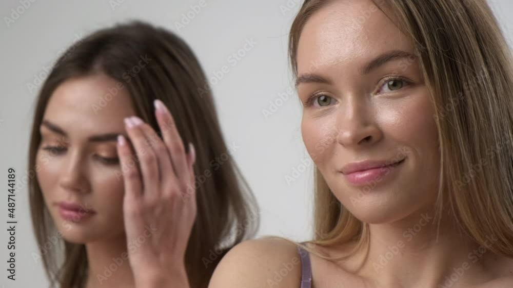 Two young multiracial women, asian and a caucasian girls, pose together on a white background. Beautiful bodies and perfect skin, cotton underwear. Two young multiracial women, asian and a caucasian girls, pose together on a white background. Beautiful bodies and perfect skin, cotton underwear.