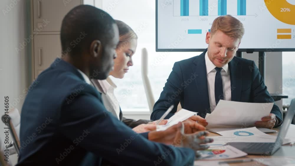 Businessmen discussing questions and analyzing corporate data in the office Businessmen discussing questions and analyzing corporate data in the office