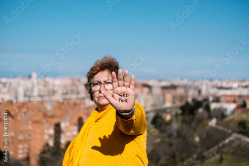 Close up of the palm of a 60 year old woman's hand with the letters GRL PWR drawn on it. Claim concept. Feminism concept.