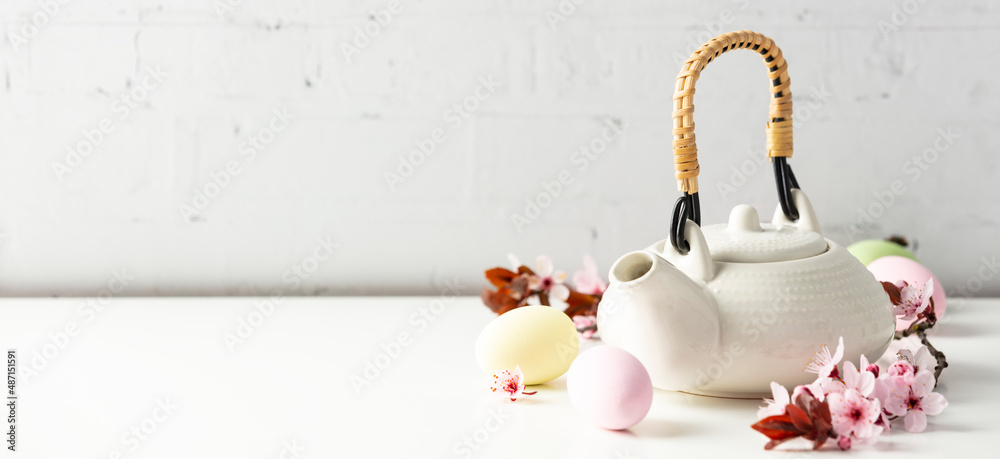 Fotografía Easter composition with White ceramic teapot, Easter eggs and spring flowers on
