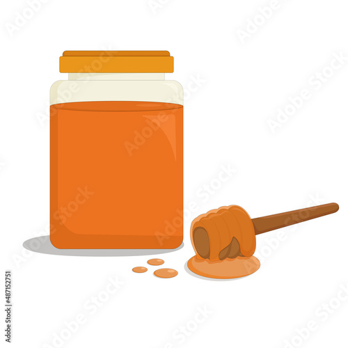 transparent glass jar of fragrant bee honey and a wooden stick